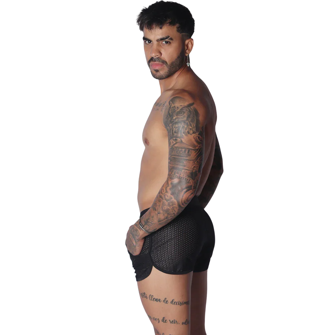 Black athletic mesh short with a curved hemline and pocket detail, worn by a shirtless man.