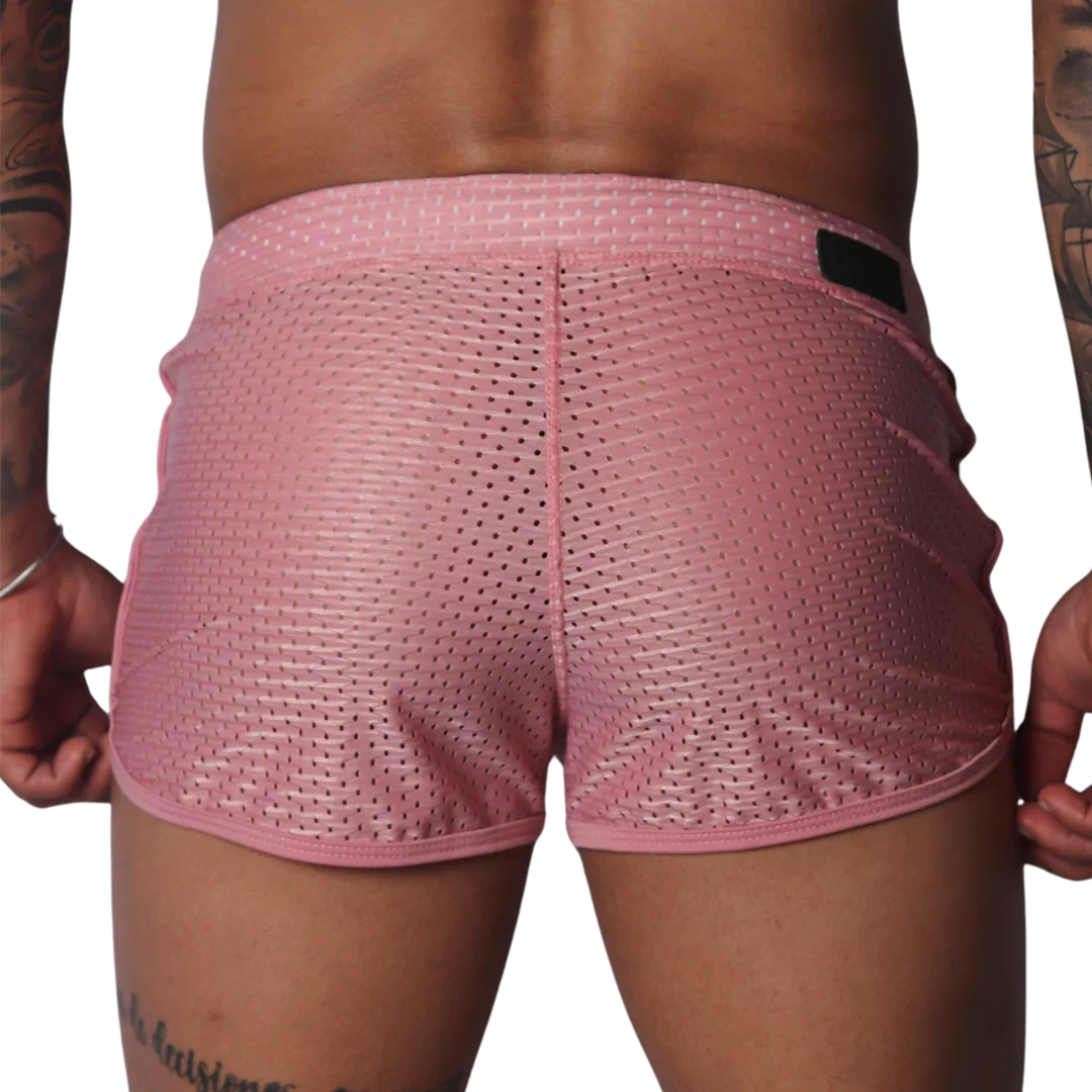 Back view of pink, breathable athletic mesh shorts with a slim fit and a dark branding patch on the waistband.