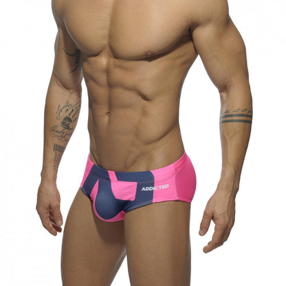 Extra-large logo brief swim trunks in bright pink and navy blue with patterned design and addicted brand name on the side