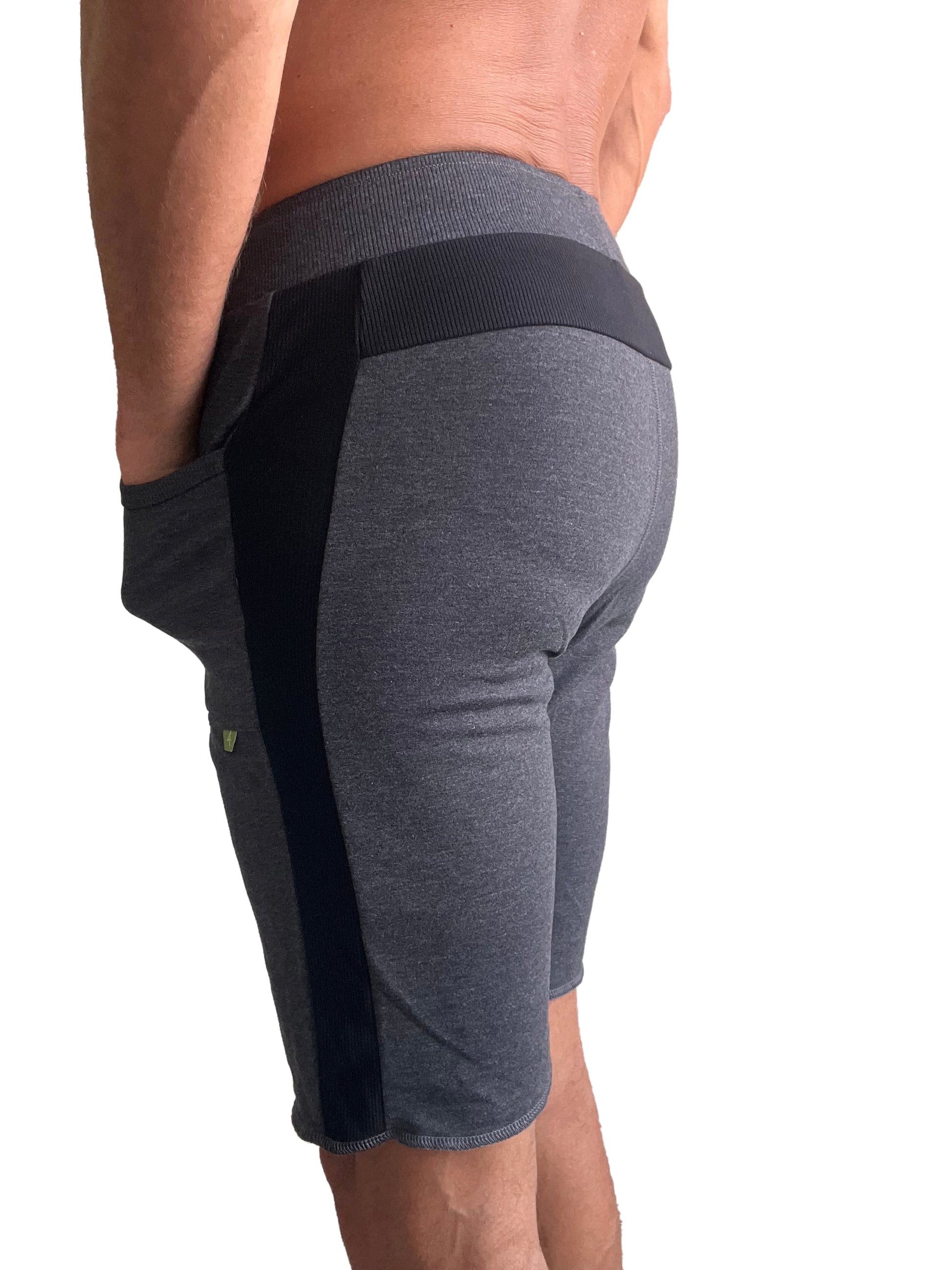 Eco-track short charcoal with black athletic shorts featuring ribbed waistband side panels and green logo on thigh