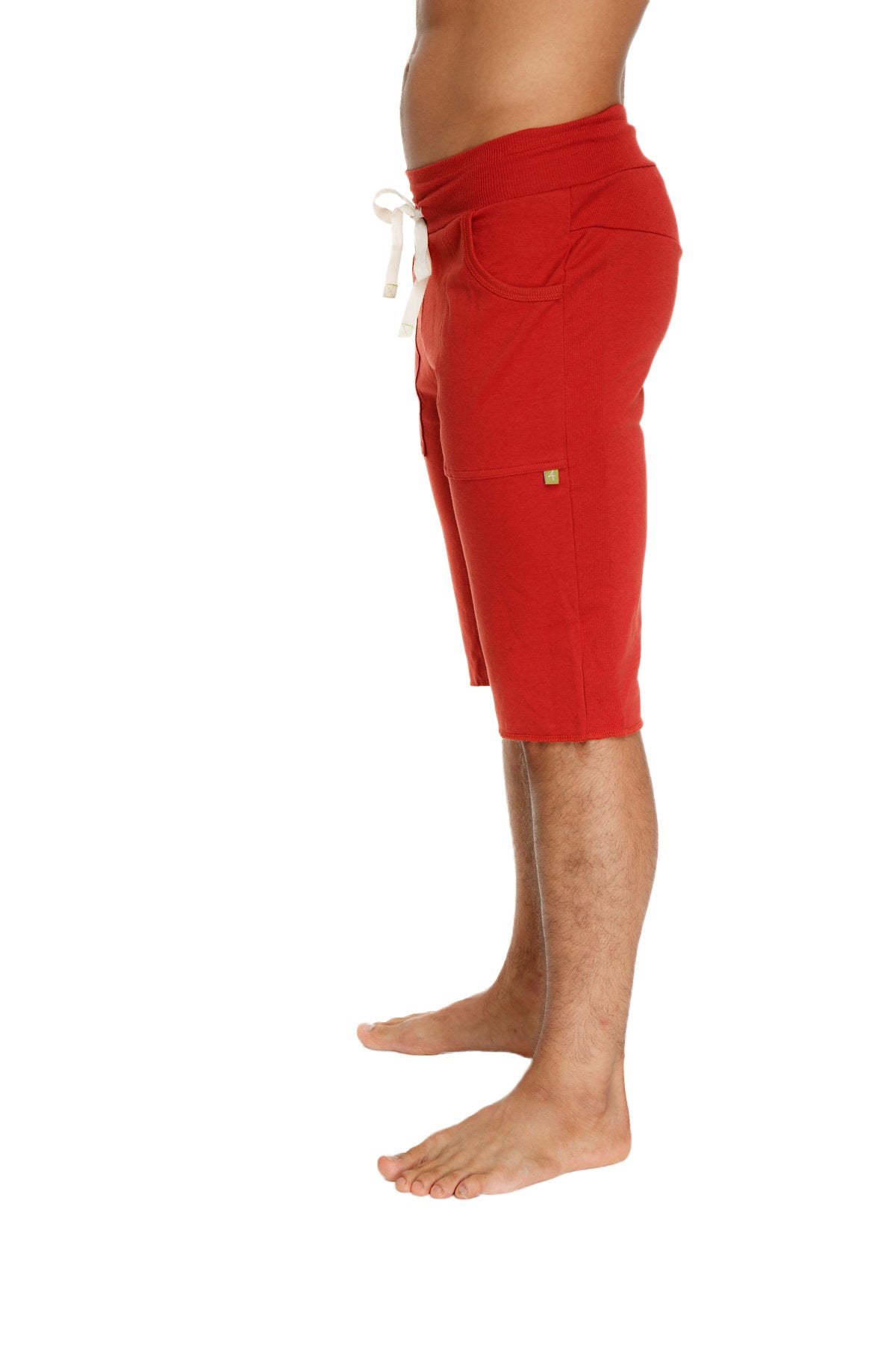Red eco-track athletic shorts in cinnabar with white drawstring and side pockets for activewear use