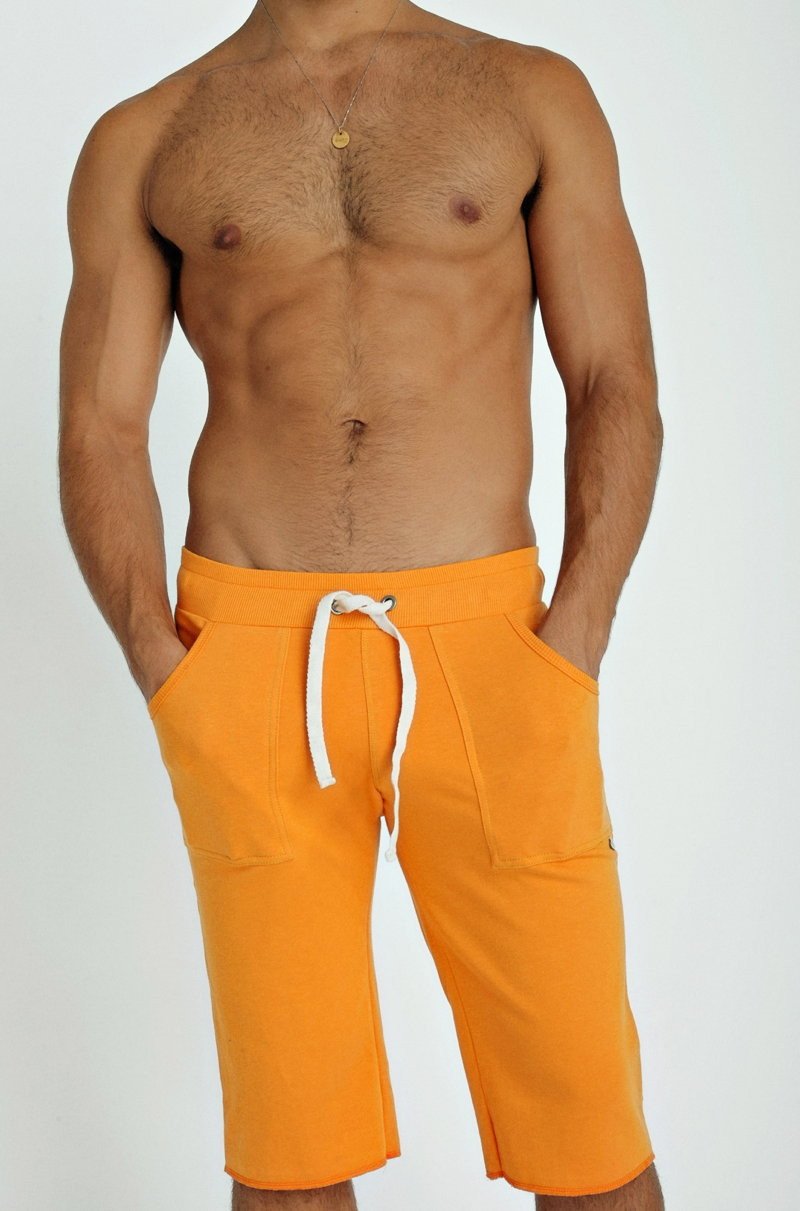 Eco-track short in sun orange with white drawstring and side pockets made for athletic use