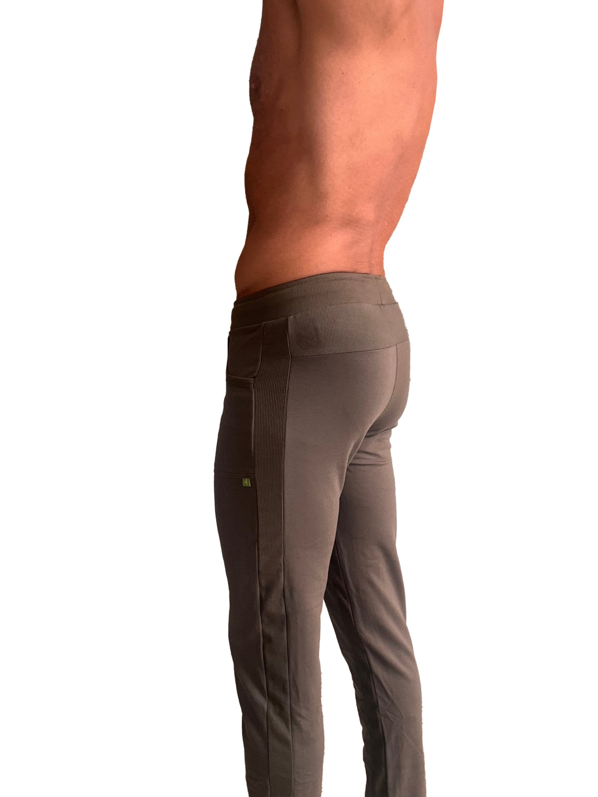 A pair of dark gray form-fitting eco-track and yoga sweat pants with ribbed side panel and subtle thigh branding