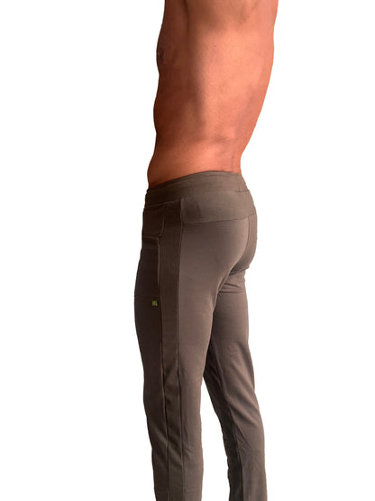 A pair of dark gray form-fitting eco-track and yoga sweat pants with ribbed side panel and subtle thigh branding