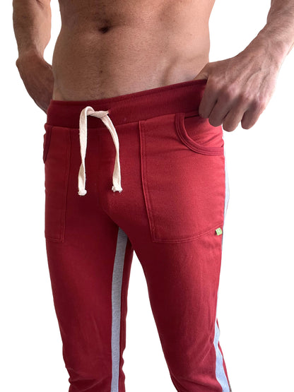 Eco-track and yoga sweat pant in cinnabar red with gray side stripes and white drawstrings for athletic use