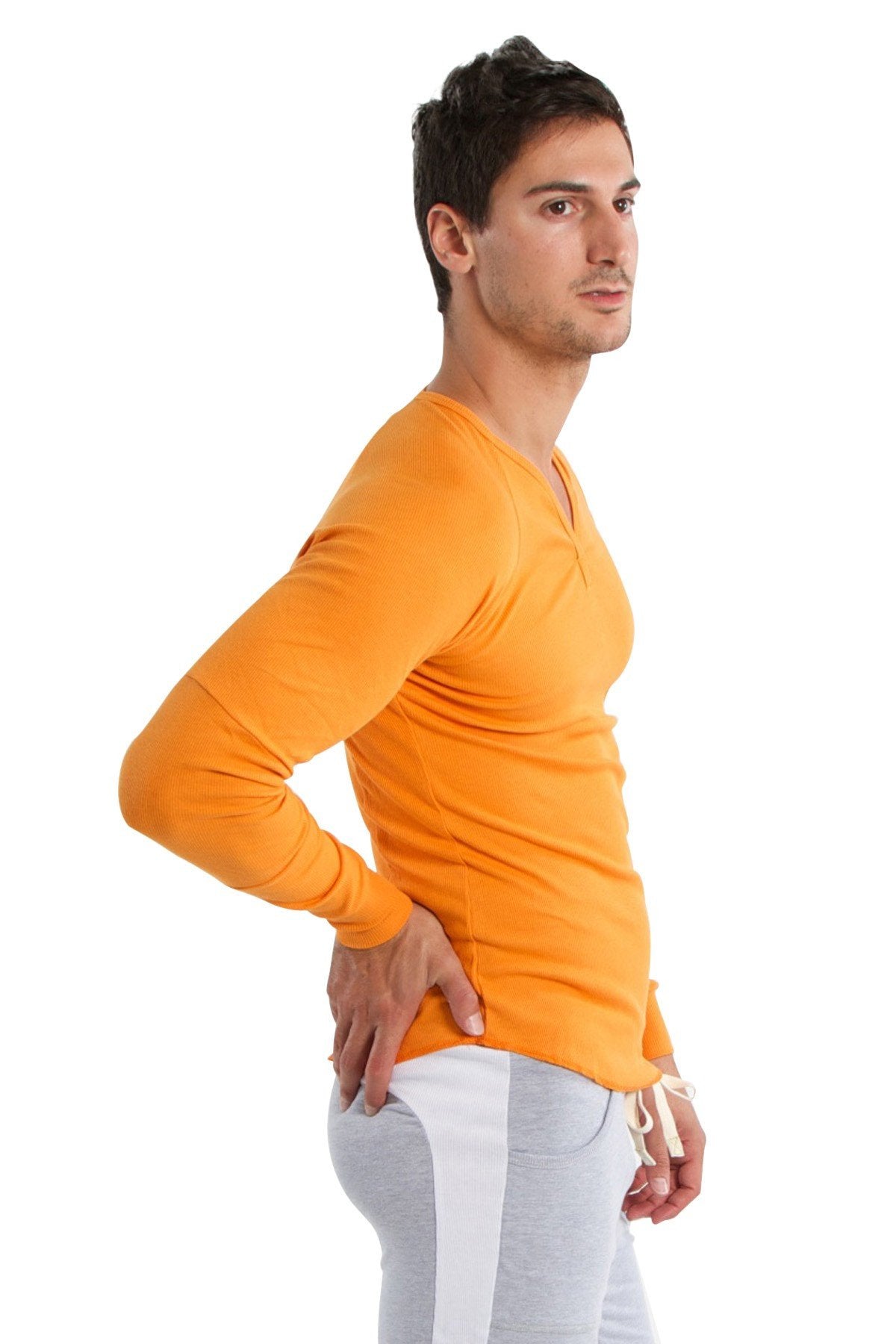 Orange long-sleeved v-neck shirt paired with heather grey eco-track and yoga sweat pant for active wear