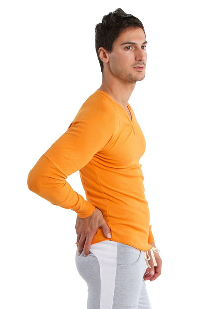 Orange long-sleeved v-neck shirt paired with heather grey eco-track and yoga sweat pant for active wear