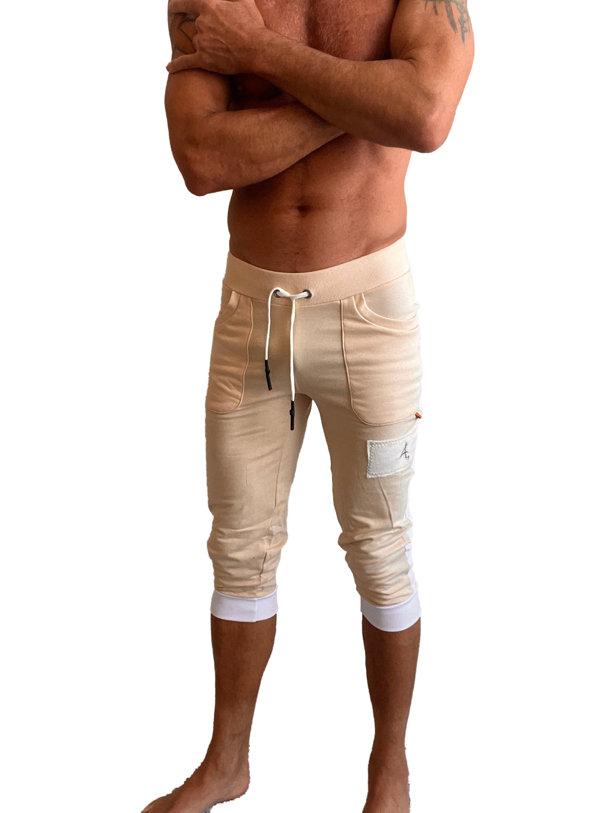 Beige edge cuffed yoga pants in capri length with white drawstring elastic cuffs and small thigh patch