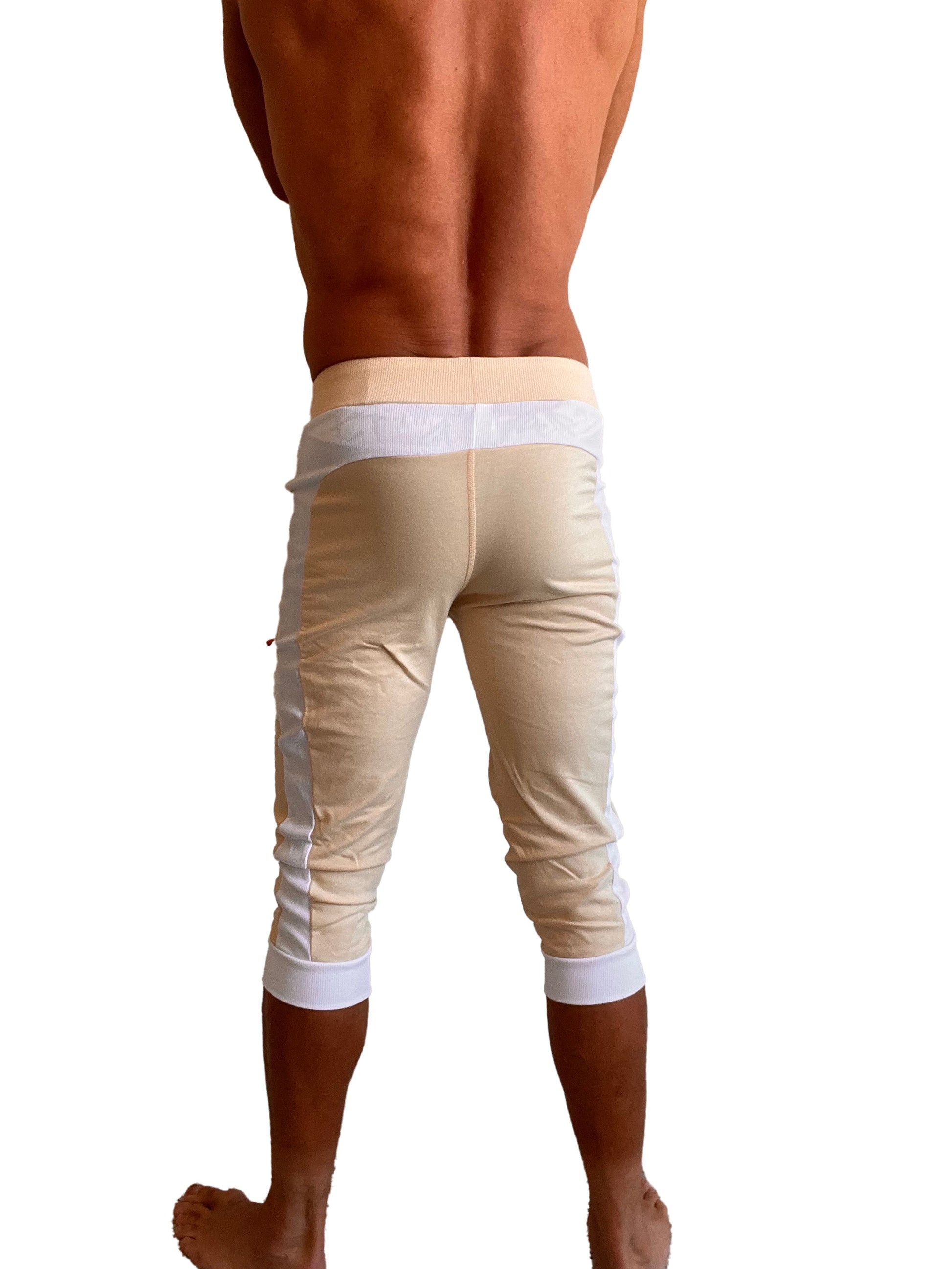 Beige edge cuffed yoga pants with white piping on waistband cuffs and side seams for comfortable activewear