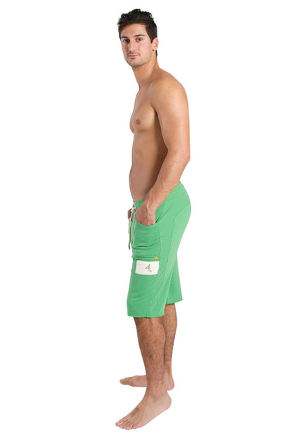 Green edge eco-track shorts made from bamboo fabric with a white patch on the side pocket