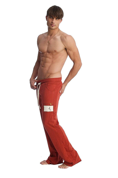 Red loose-fitting edge eco-track and yoga sweat pants with white drawstring and thigh patch in cinnabar color