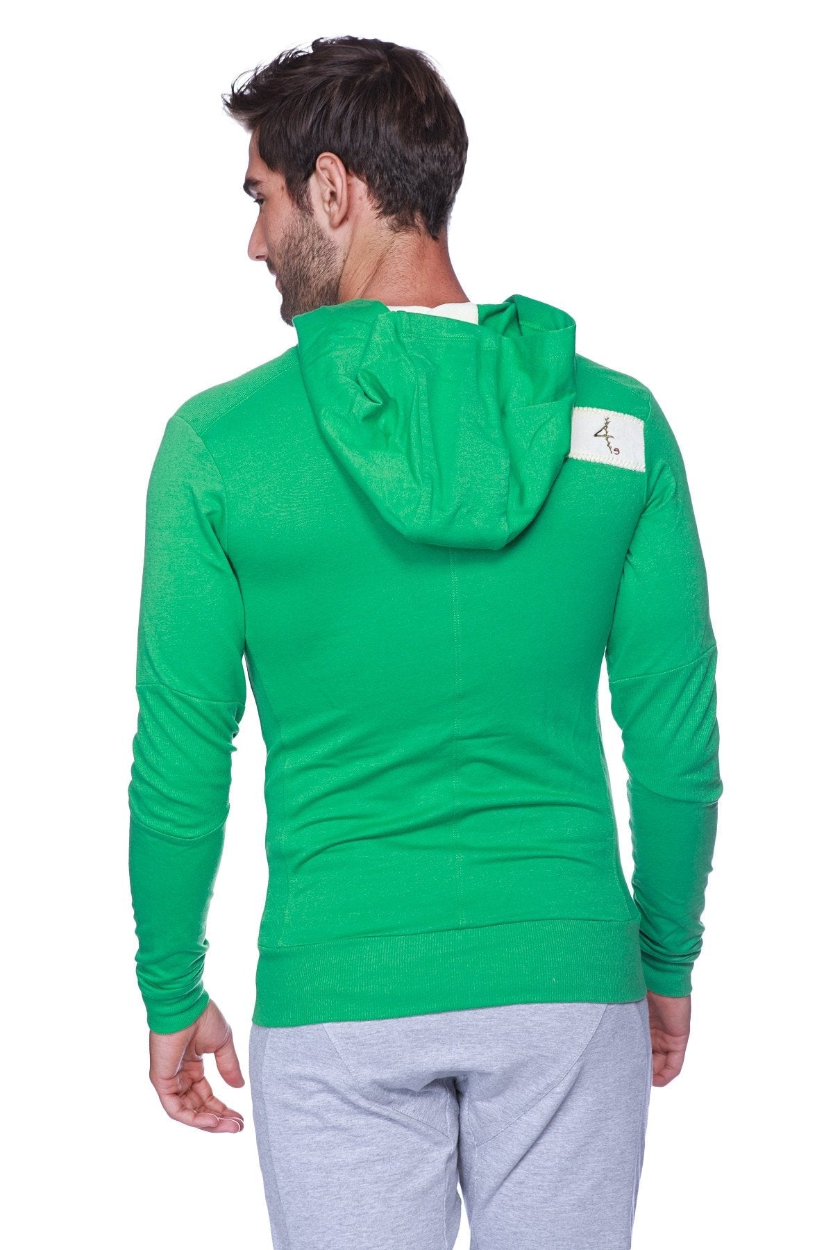 Back view of edge form-fit crossover yoga track performance hoodie in bamboo green with white patch on upper back