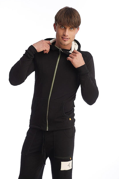 Black zip-up edge form-fit crossover yoga track hoodie with light green zipper and white inner lining for performance