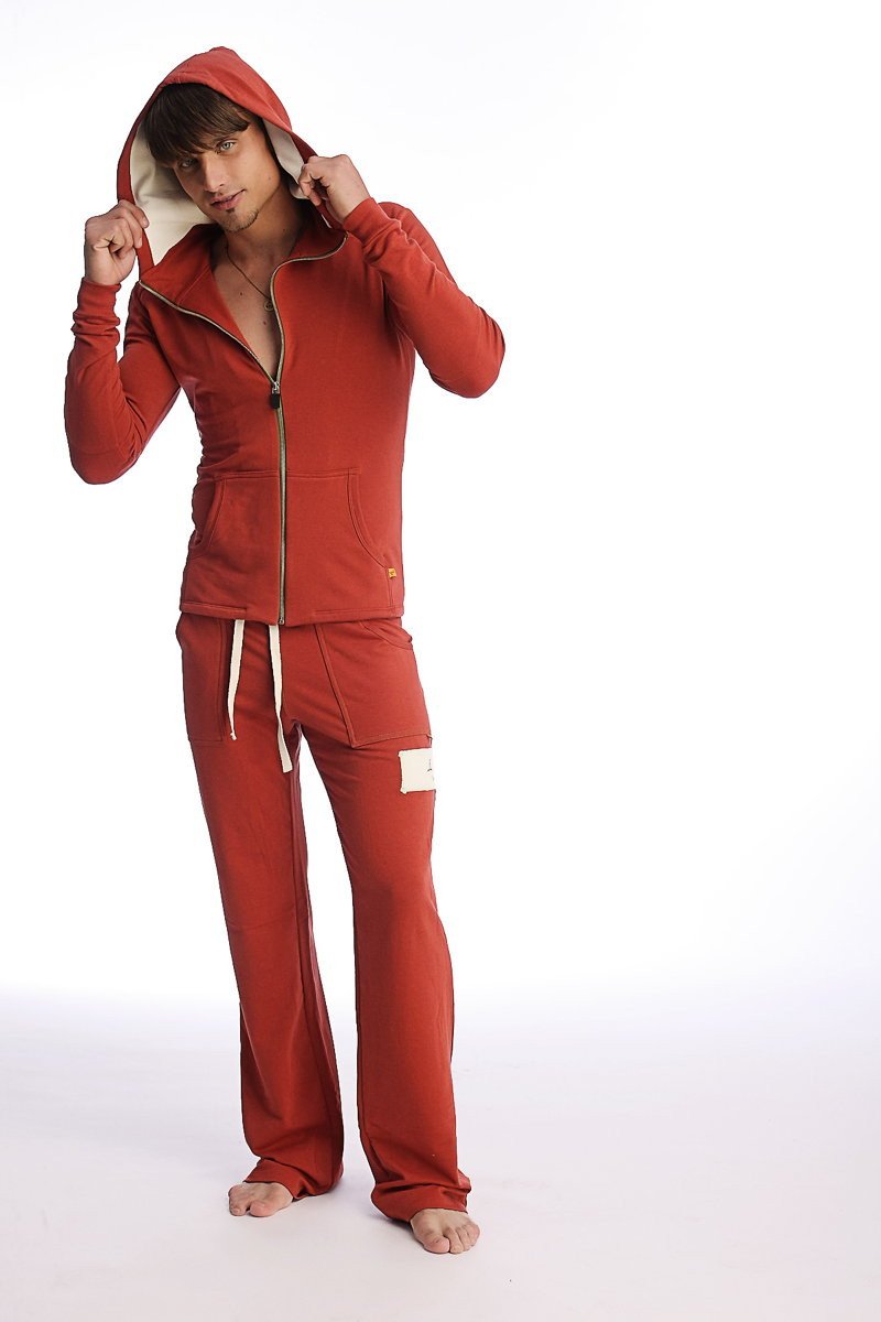 Red hooded zip-up sweatshirt and matching pants set in cinnabar designed for yoga and performance wear