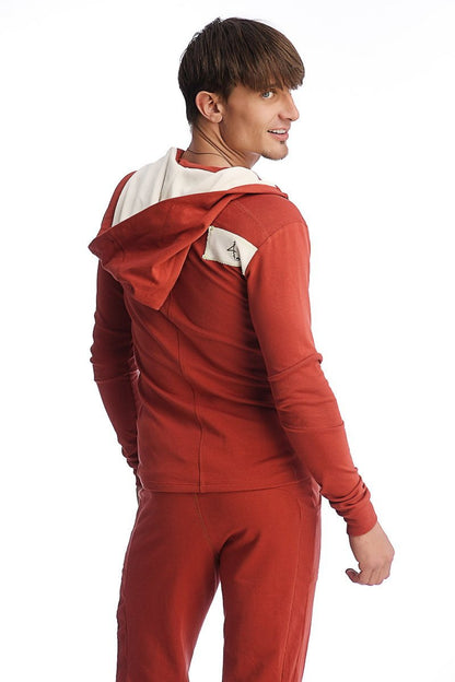 Back view of cinnabar red edge form-fit crossover yoga track performance hoodie with white interior lining and shoulder patch