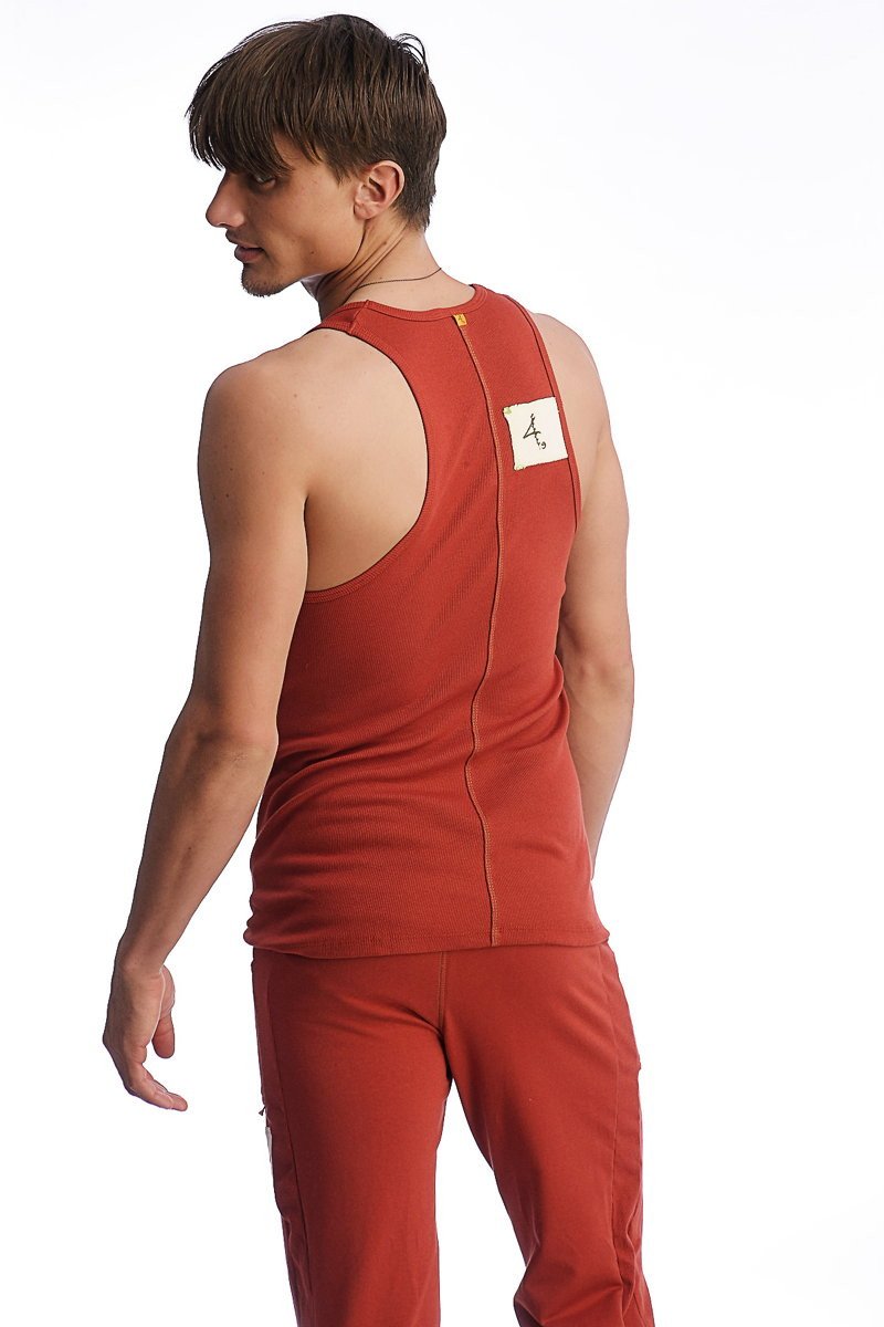 Back view of edge sustain tank top cinnabar in rust red with central zipper and small white label near neckline