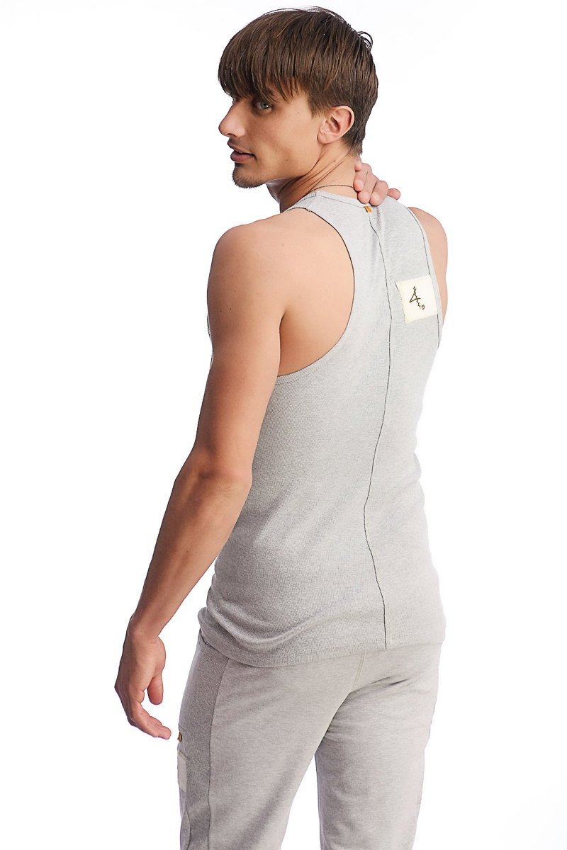 Back side of edge sustain tank top in heather grey with subtle vertical seam and small white label near shoulder