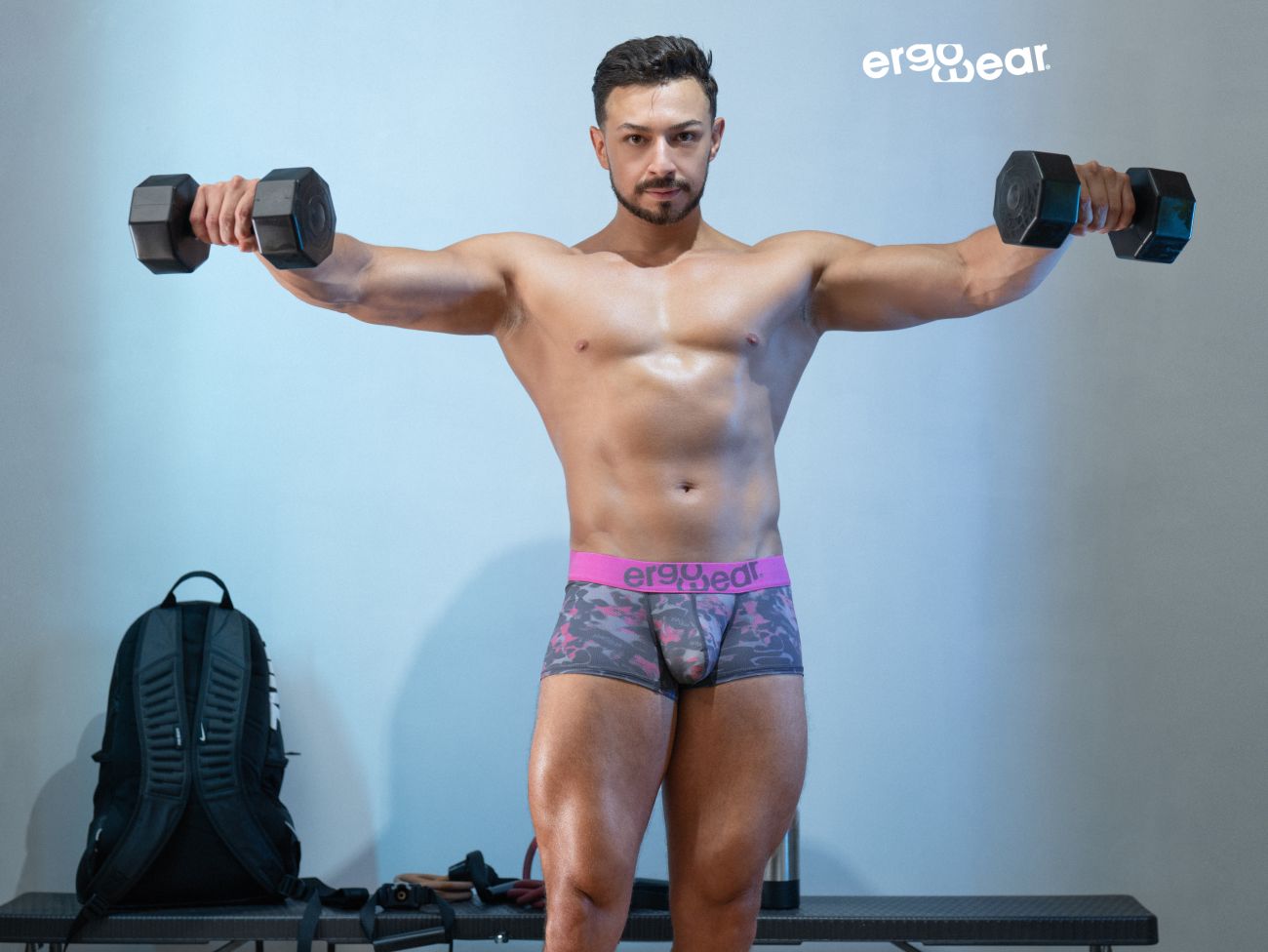 Black hexagonal dumbbells paired with ergowear ew1716 max se camo trunks in pink color for fitness use