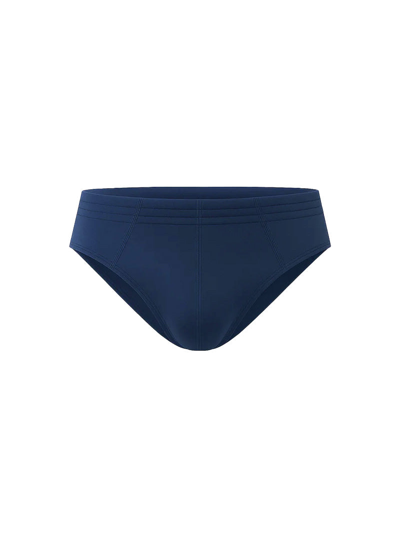 Navy blue essential cotton brief swim trunks with smooth stretchy fabric and subtle horizontal waistband stitching