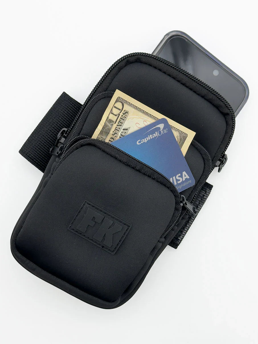 Black fk sport 3 pocket neoprene arm pouch with zippered compartments holding cash and a phone