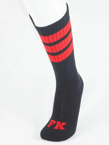 Black athletic tube sock with bold red stripes and matching fk logo on the toe for sport use