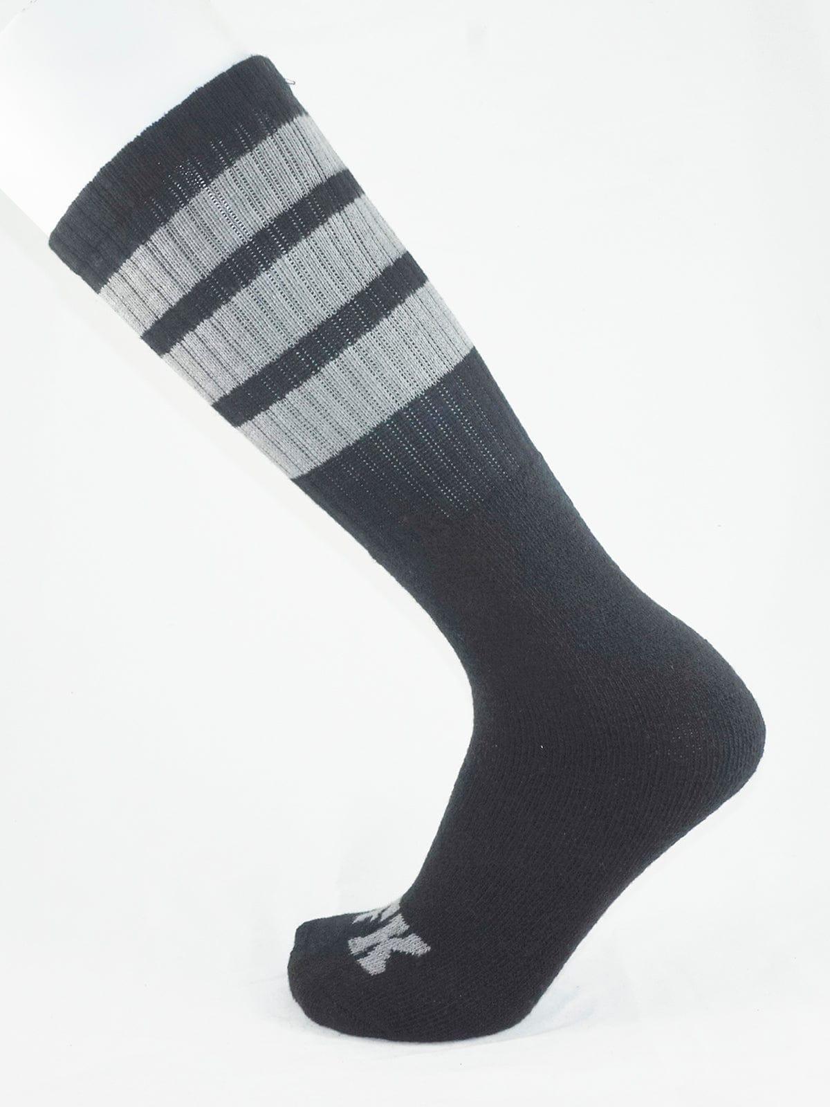 Fk sport black tube sock with ribbed texture and three horizontal stripes on top cuff for athletic use