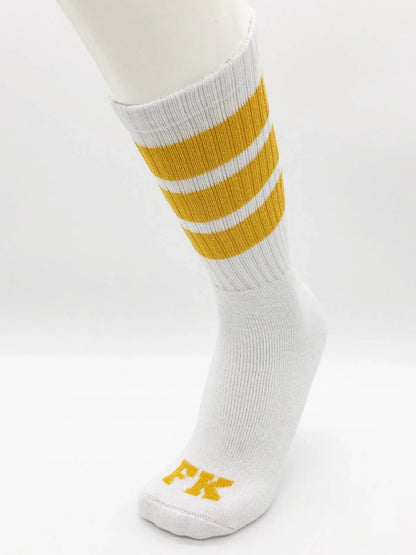 Fk sport white tube sock featuring white athletic fabric with three mustard-yellow stripes and fk logo on the toe