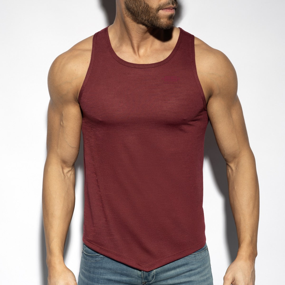 A maroon sleeveless flame tank top with rounded neckline and curved hemline for casual wear