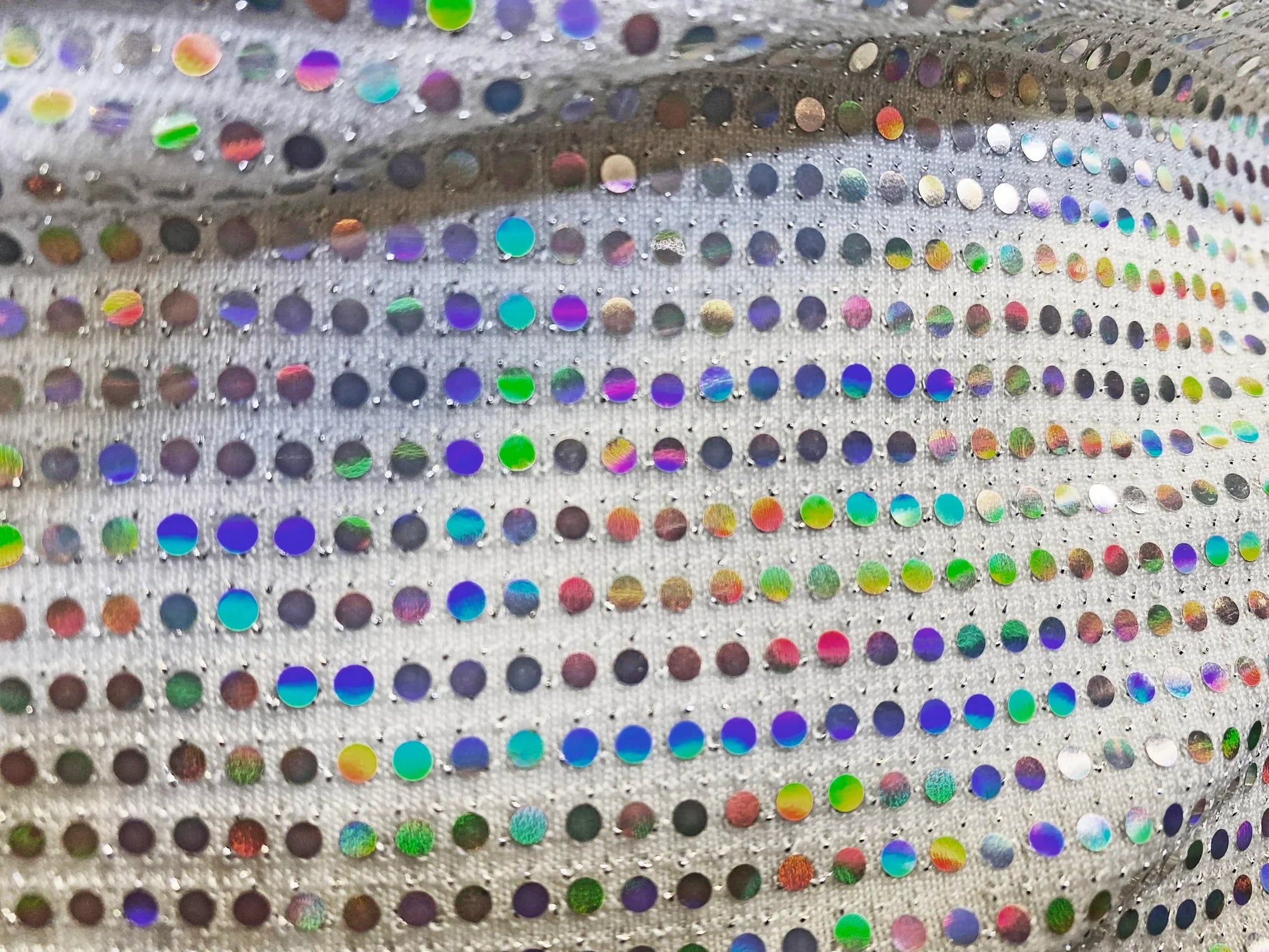 Flat sequin hooded crop top with shimmering silver fabric and iridescent multicolored sequins in a grid pattern