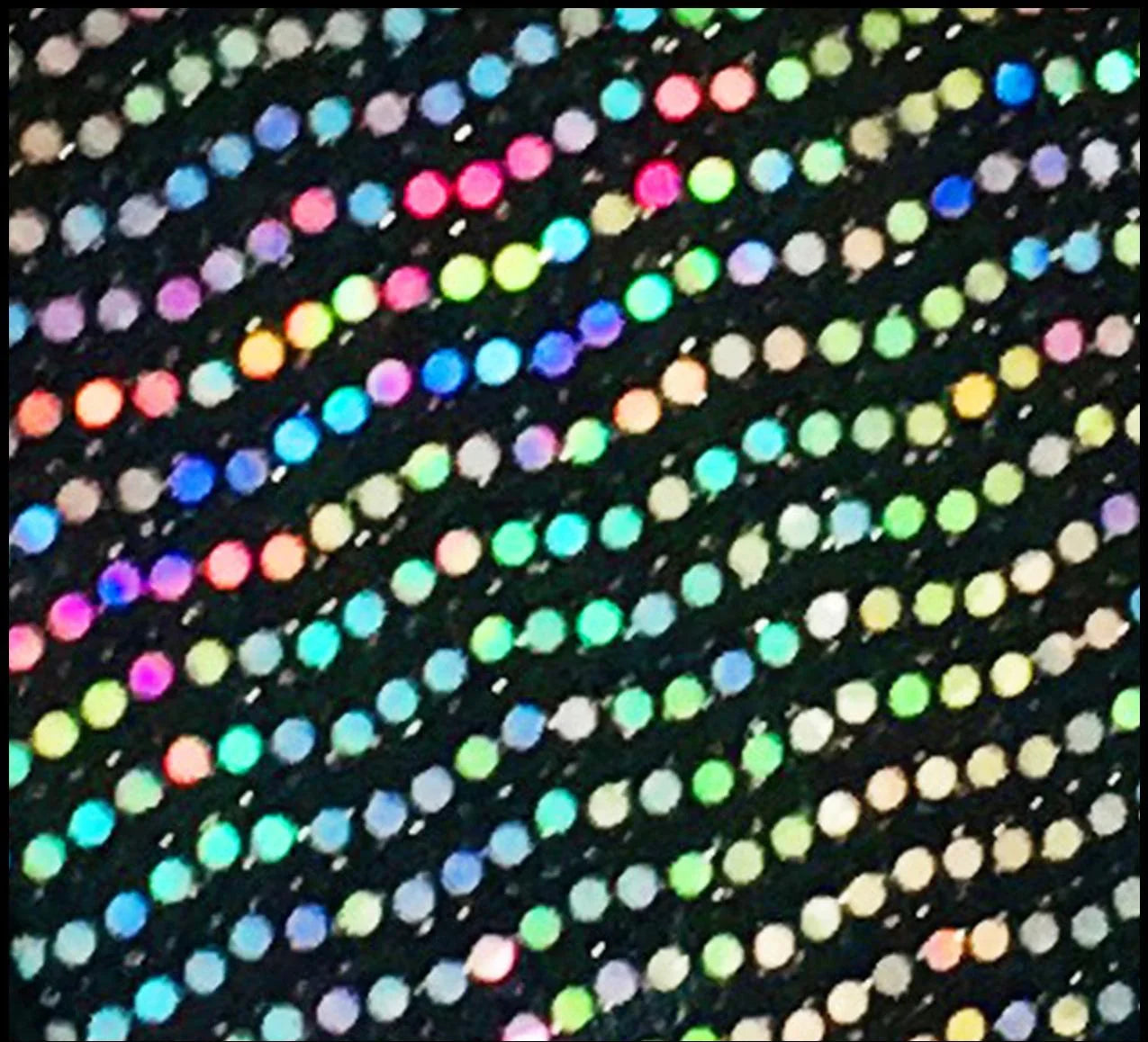 Flat sequin short made of black fabric with dense multicolored iridescent flat sequins in pink blue green yellow and silver