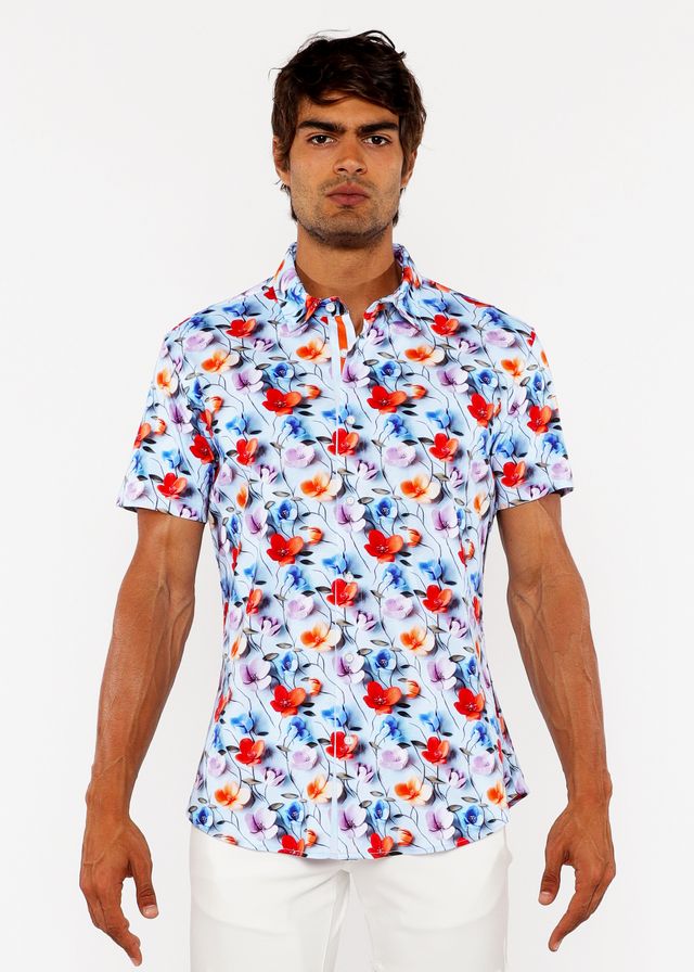 A white floral 3d print stretch knit shirt with bold red and blue blossoms and delicate pink accents