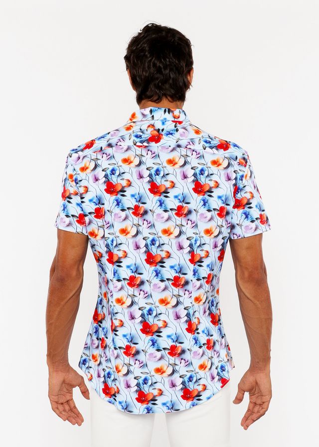 A vibrant floral 3d print stretch knit short-sleeved men’s shirt with red orange blue and purple blossoms on light blue