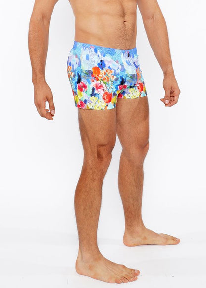 Floral abstract printed swim shorts with vibrant floral pattern in red orange yellow and blue perfect for beachwear