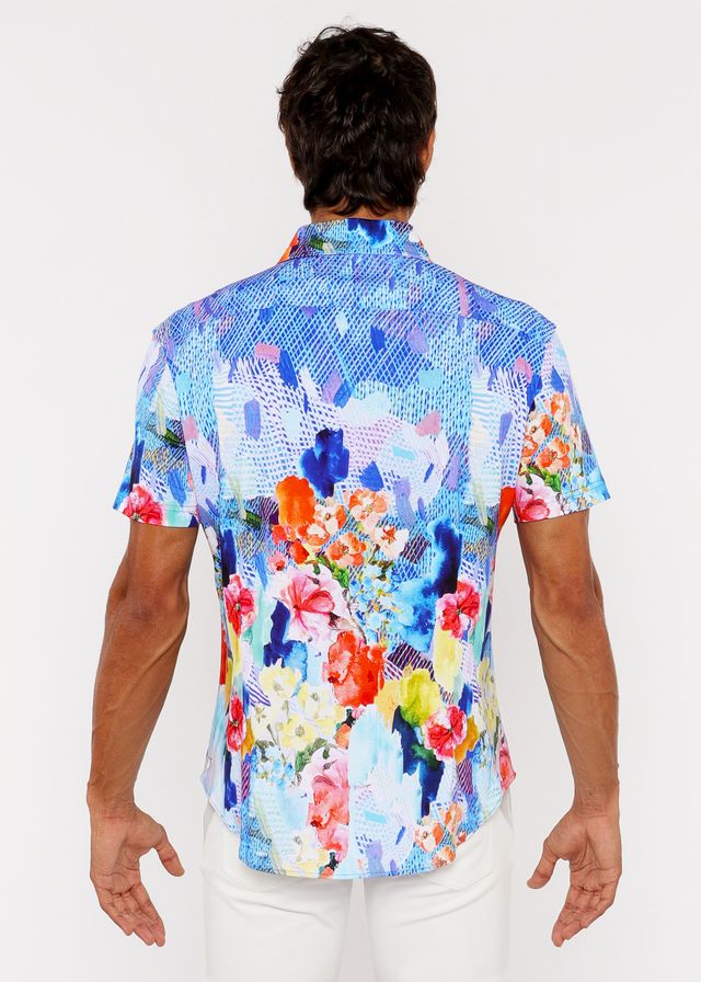 A vibrant short-sleeved woven modal button-up shirt with bold blue pink orange and yellow abstract floral pattern