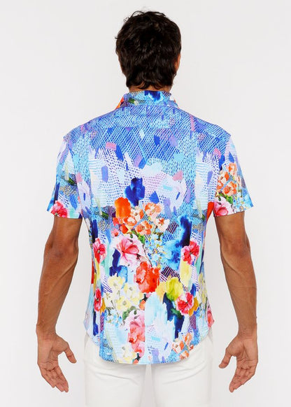 A vibrant short-sleeved woven modal button-up shirt with bold blue pink orange and yellow abstract floral pattern