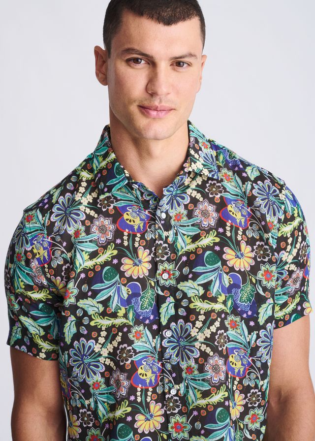 A vibrant floral lightweight linen tencel short-sleeved shirt with green blue yellow and purple pattern on dark background