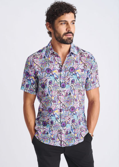 A floral lightweight linen tencel short-sleeved button-up shirt with purple blue and pink pattern on lavender background