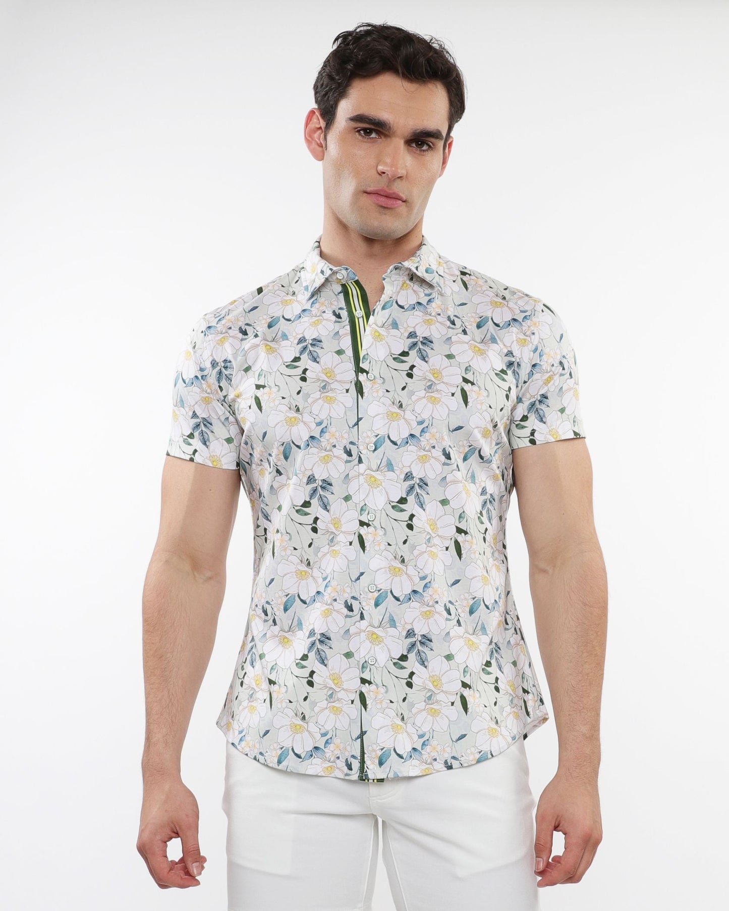 White short-sleeved stretch knit shirt with green blue and yellow floral print pattern