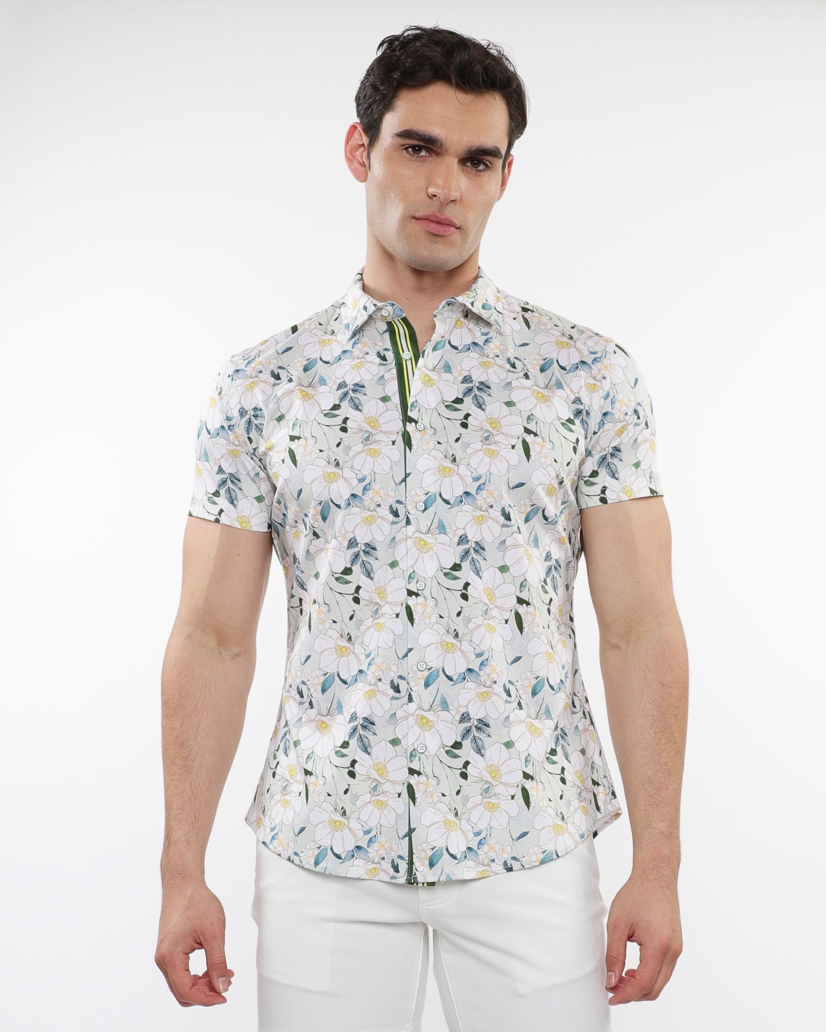 White short-sleeved stretch knit shirt with green blue and yellow floral print pattern