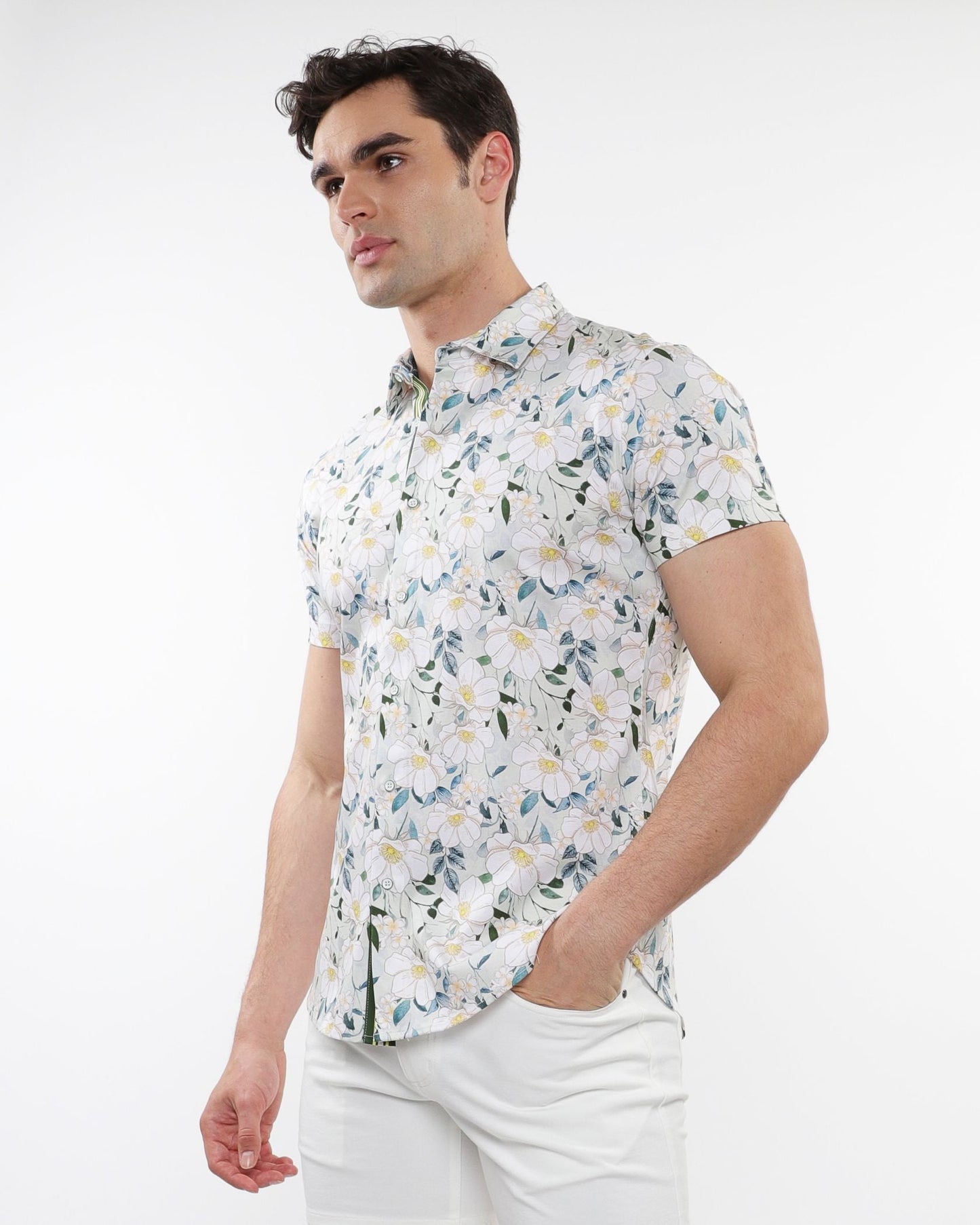White short-sleeved stretch knit shirt with delicate green and yellow floral print pattern