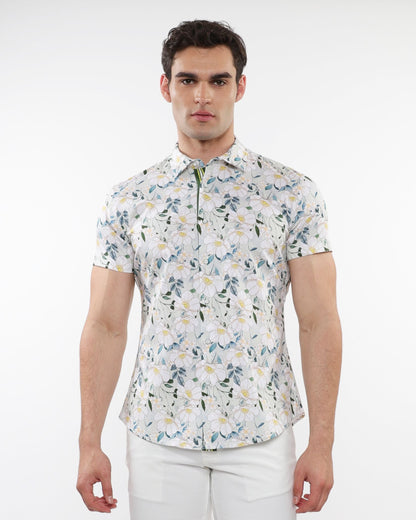 A man wearing a white floral print stretch knit short-sleeved shirt with green and yellow accents