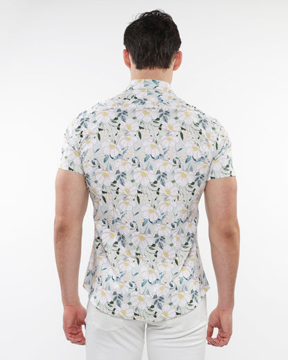 A man wearing a white floral print stretch knit short-sleeved shirt with green blue and yellow pattern