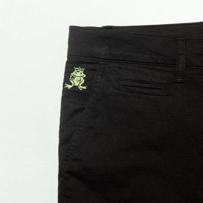 Back side of black denim frog chino short featuring an embroidered green frog with crown on the pocket