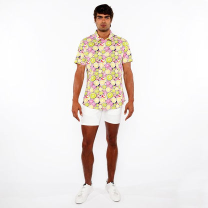A vibrant fruits print stretch knit short-sleeved shirt with lemon lime pattern in yellow green pink and black on light background