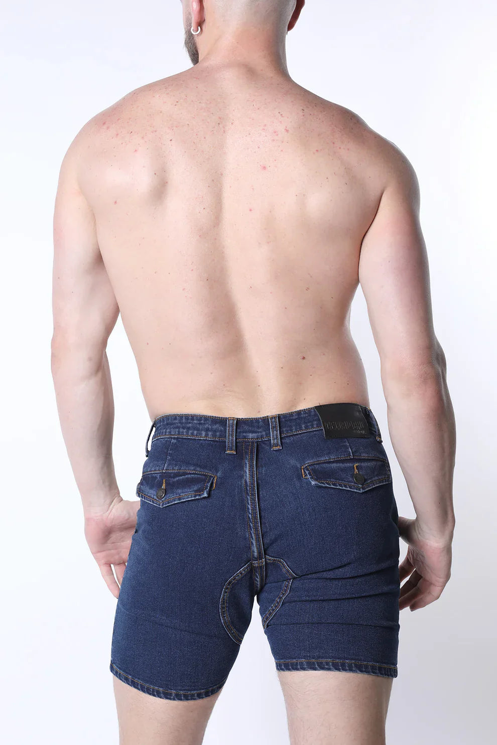 Dark blue full court denim zipper shorts showing the back with five-pocket design and black leather brand patch