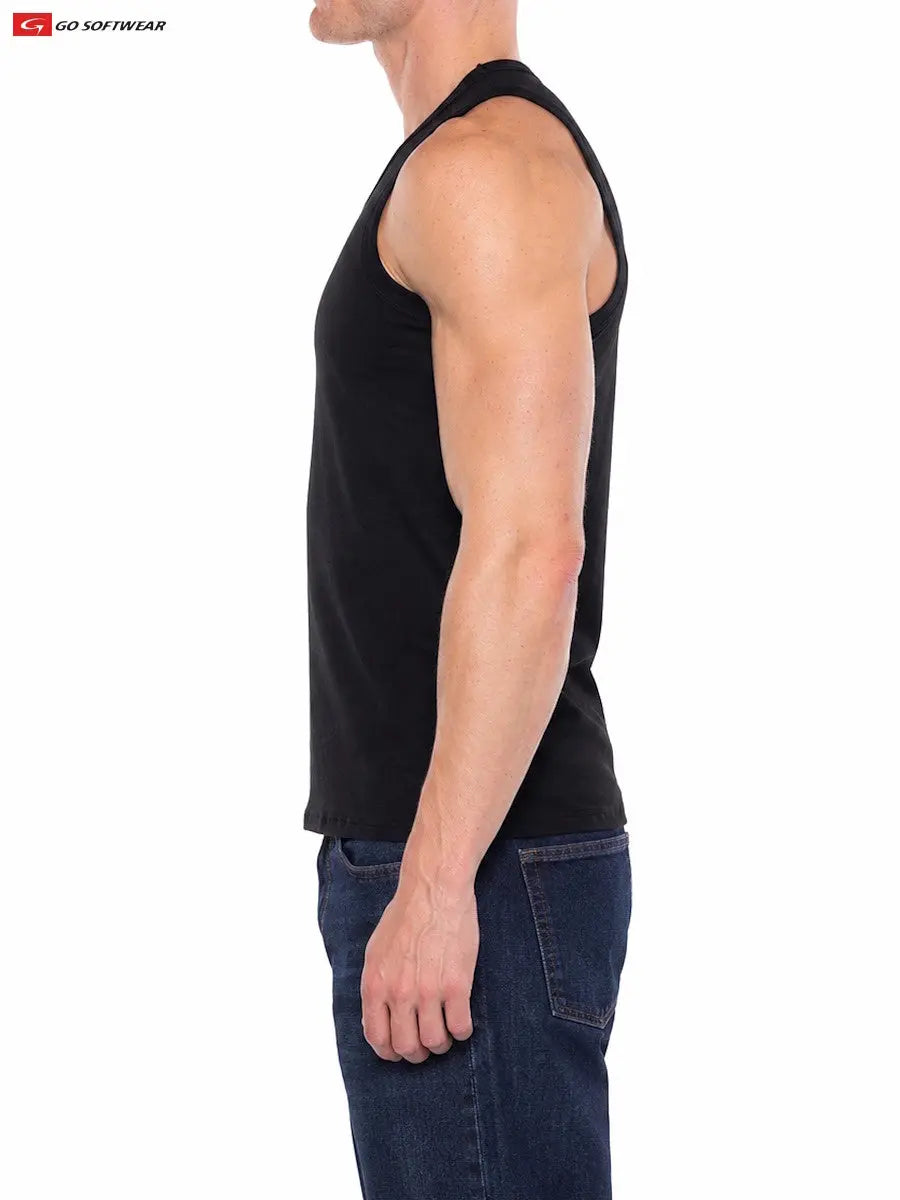 A model wearing a black tank top from Go Softwear showcasing a fitted style and muscular silhouette paired with blue jeans