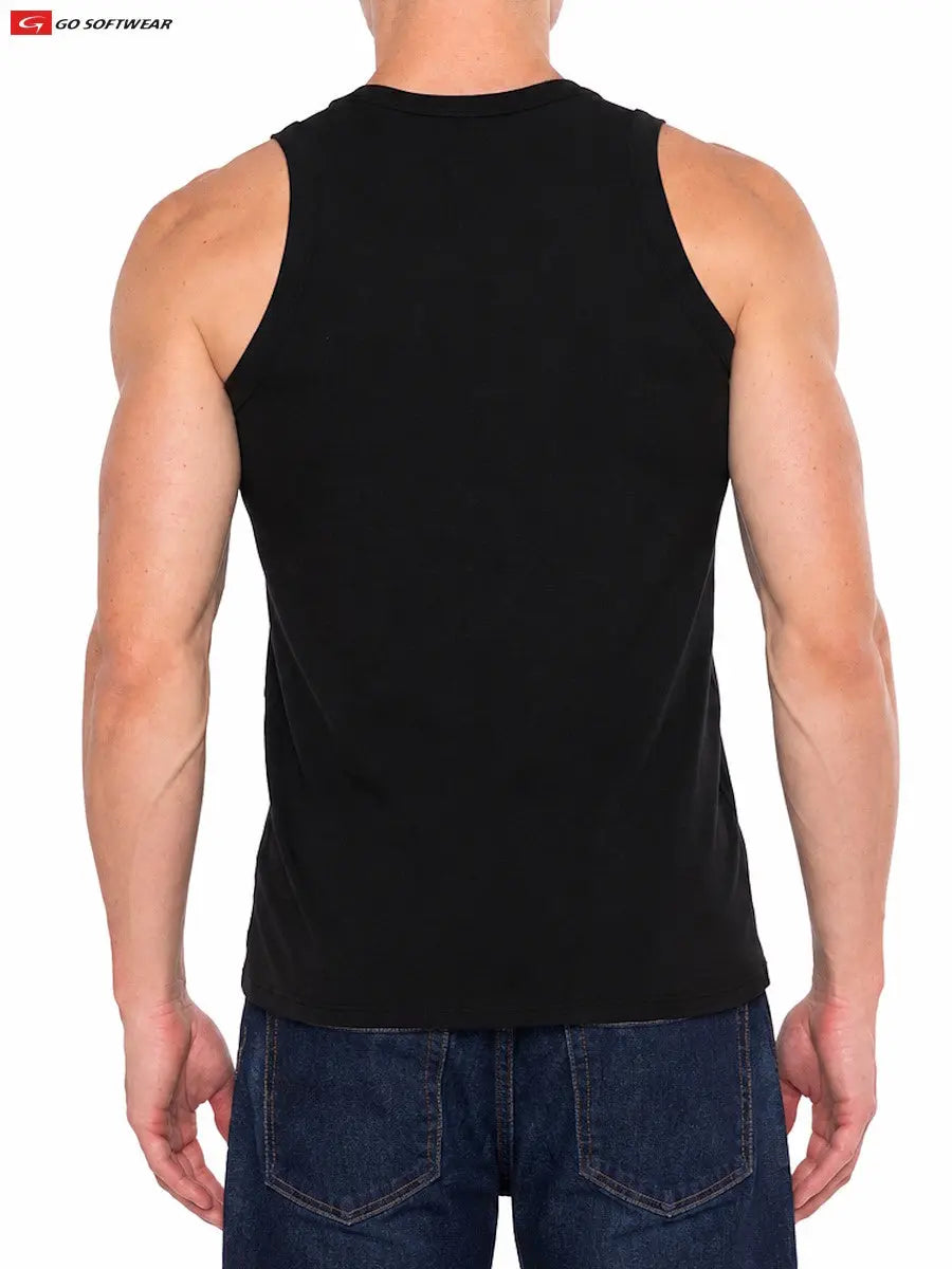 Model wearing a black tank top from Go Softwear showcasing a fitted style and sleeveless design paired with blue jeans