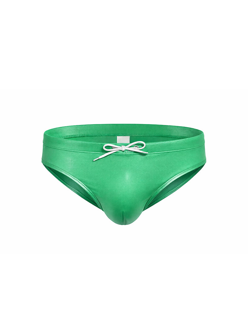 Vibrant green glossy faux leather swim trunks with white drawstring bow in fizx swim bikini with removable push pad