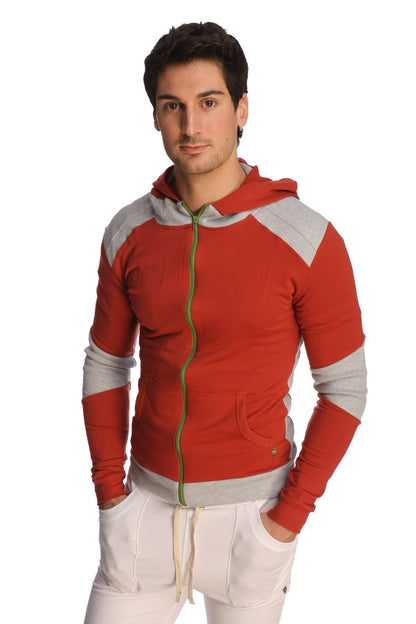 Form-fit crossover yoga track performance hoodie in cinnabar grey with red and gray panels, green zipper pull, and front pockets