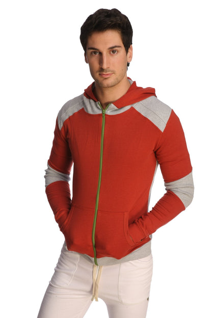 Form-fit crossover yoga track performance hoodie in cinnabar grey with red and gray zip-up design and green zipper pull